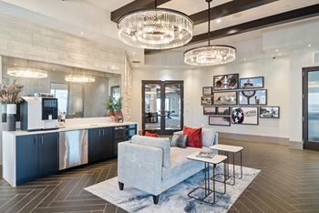 a living room with a couch and a kitchen